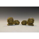 Pair of antique cast brass door stops in the form of recumbent lions, each 12.5cm high