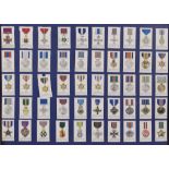 Four framed complete sets of cigarette cards to include; Players Regimental Medals and Military