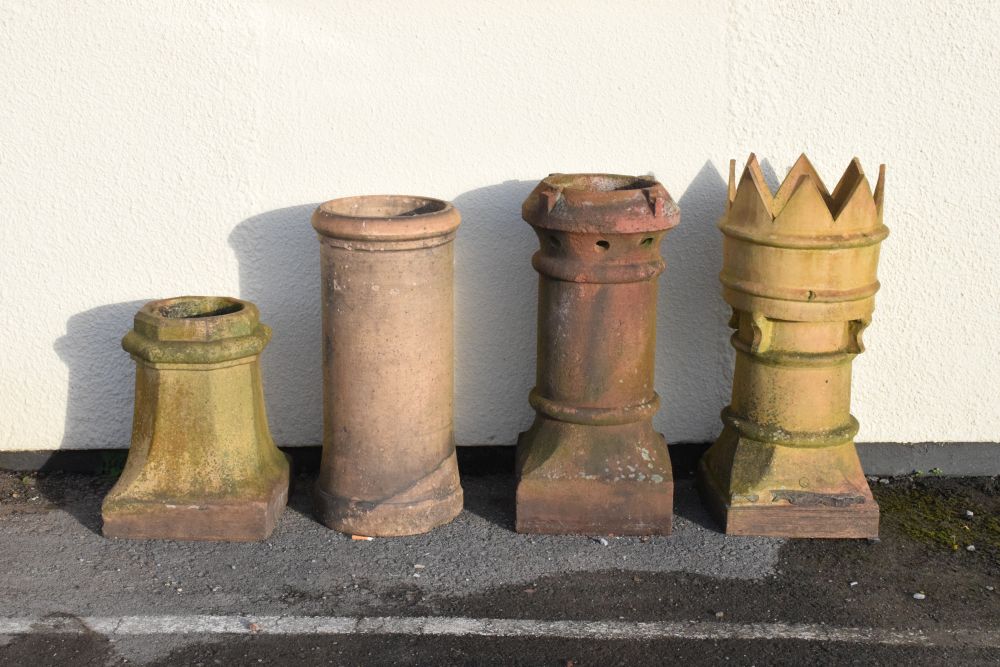 Four terracotta chimney pots, the tallest crown example standing 72cm high