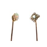Two yellow metal stickpins, one set opal cabochon, the other seed pearls and aquamarine-coloured