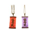 Two Oriental yellow metal and hardstone pendants, together with two yellow metal chains, each