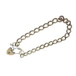 Yellow metal curb-link bracelet with heart-shaped padlock, indistinctly stamped, 29g approx