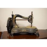 Victorian cast iron gilt decorated 'C' frame sewing machine by Jones, 26cm high