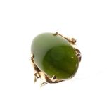 Yellow metal and green hardstone dress ring, with oval cabochon (possibly nephrite jade), shank