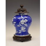 Chinese porcelain blue and white prunus jar and cover, the turned pierced domed wooden cover over