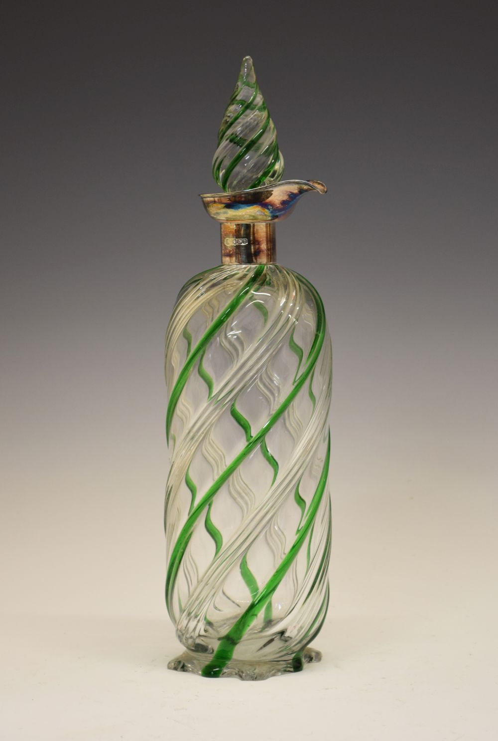 Late Victorian silver-mounted clear and green glass decanter bottle, with spirally-moulded tear drop