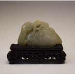 Chinese carved jade ornament modelled as a recumbent stork or crane clutching a branch in its