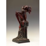 Unusual large early to mid 20th Century earthenware figure of devil, modelled seated atop a pedestal