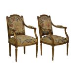 Pair of 19th Century Louis XVI- style giltwood fauteuils, each having a shaped arched padded back