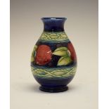 William Moorcroft baluster vase decorated with the banded Pomegranate pattern on a blue ground