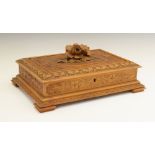Early 20th Century 'Black Forest' carved linden wood jewellery casket, the hinged rectangular