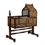 Victorian mahogany and bergere rocking cradle or crib, with caned lancet-arch canopy, rectangular