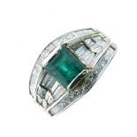 Emerald and diamond dress ring, the white mount stamped '18k', the step cut stone between baguette