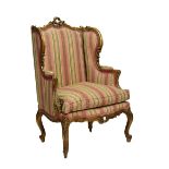 Louis XV-style giltwood wing-back fauteuil or occasional chair, the shaped padded back with