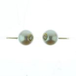 Pair of cultured pearl and diamond earstuds, the 9mm pearls drilled and set to the centre with a