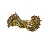 Ruby set bow brooch, tagged '750', probably Italian, 1950's, 5.2cm long, 13.7g gross Condition: No