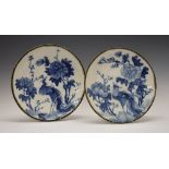 Pair of early 20th Century Oriental pottery plates, probably Japanese, each decorated in