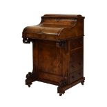Early Victorian figured walnut piano-top Davenport, the concealed superstructure with hinged rounded