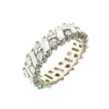 Diamond eternity ring, in unmarked white metal, alternate set with baguette cut and pairs of