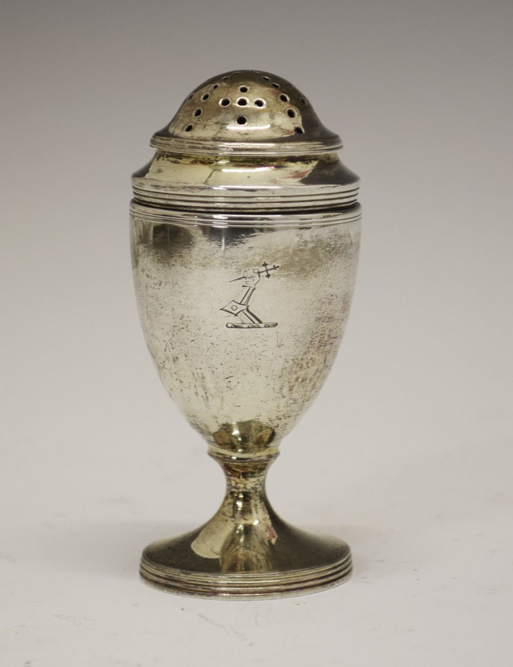 George III silver pepperette, of neoclassical urn form, with engraved armorial, London 1797, sponsor