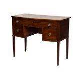 19th Century mahogany bowfront dressing table or kneehole desk, the top with reeded edge over curved