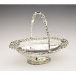 Edward VII silver oval cake basket, with pierced swing handle over wavy oval body having scroll-