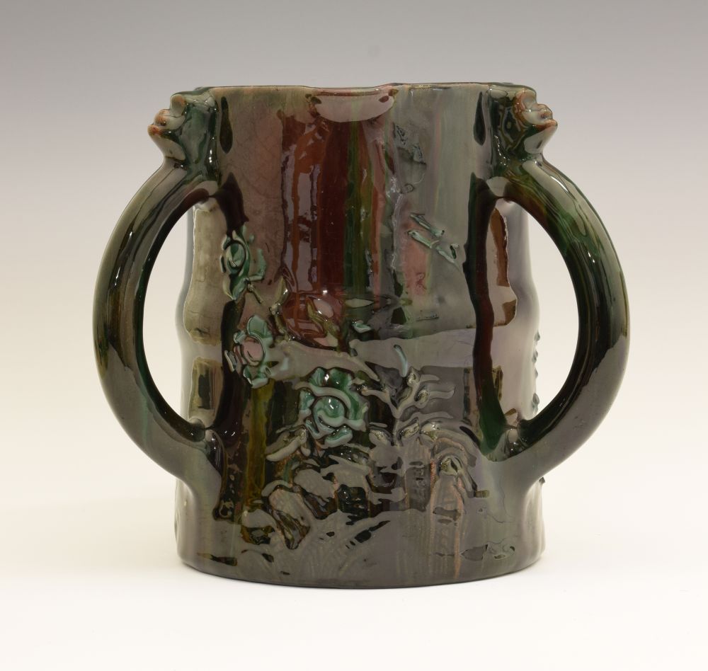 Elton Ware tyg, each loop handle with a mask head capital, decorated with flowers on a green/red