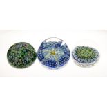 Three assorted paperweights comprising: a millefiori example with unusual emerald green and silver