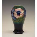 William Moorcroft 'Anemone' pattern pottery baluster vase, with tube-lined decoration on a ground