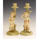 Pair of late Victorian Royal Worcester porcelain figural candlesticks modelled by James Hadley, as a