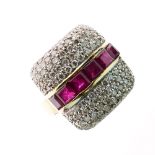 Ruby and diamond ring, with a central line of calibré cut rubies between pavé set diamond shoulders,