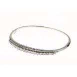 Diamond set hinged bangle, in 18ct white gold, the graduated stones totalling approximately 0.8