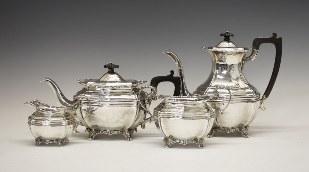 Edward VII silver four piece tea set of shaped form with scroll borders and standing on four shell