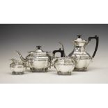 Edward VII silver four piece tea set of shaped form with scroll borders and standing on four shell