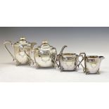 George V silver four piece tea set of rounded rectangular shape and having engraved floral