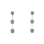 Pair of diamond drop earrings, in unmarked white metal, the graduated brilliant cuts totalling