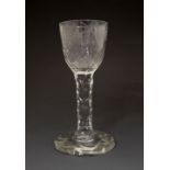 18th Century facet-cut cordial glass, the rounded funnel bowl engraved with flowers over facet-cut