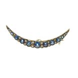 Sapphire and diamond crescent brooch, circa 1900, the graduated oval cuts with pairs of small old