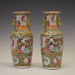 Pair of Chinese Canton Famille Rose porcelain vases, each decorated in enamels with figures on a