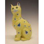 Continental faience model of a seated cat in the manner of Emile Gallé, having green glass eyes,