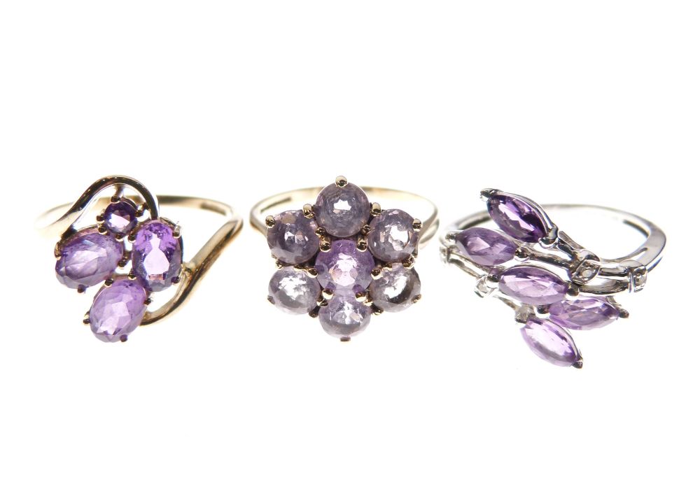 Two 9ct gold dress rings set purple stone, together with a similar white metal dress ring stamped