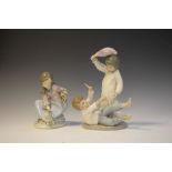 Lladro porcelain figure of a crouching girl, together with a Nao figure group of two children pillow