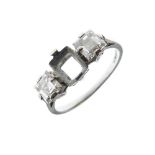 Platinum and diamond ring of two square-cut stones, each approximately 4mm, flanking vacant