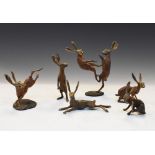 Michael Storey - Six assorted cold-painted bronze hares to include a fighting pair, largest 11cm