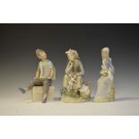 Two Lladro porcelain figures, girl with doll (5400) seated girl holding lilies, and a Nao figure