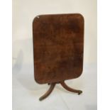 George IV mahogany tilt-top breakfast table with rounded oblong top on turned stem and three