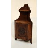 Late 19th century stained beech wall hanging corner cupboard, fitted one chip carved blind panel