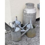 Galvanised milk churn, 72cm high and three watering cans