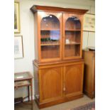 Victorian walnut two section bookcase, the upper fitted two arched glazed doors, base with two blind