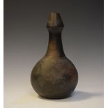 African pottery bottle shaped vase having incised decoration to the bulbous neck and shoulder,